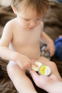 applying natural alternative to aquaphor to a child's skin